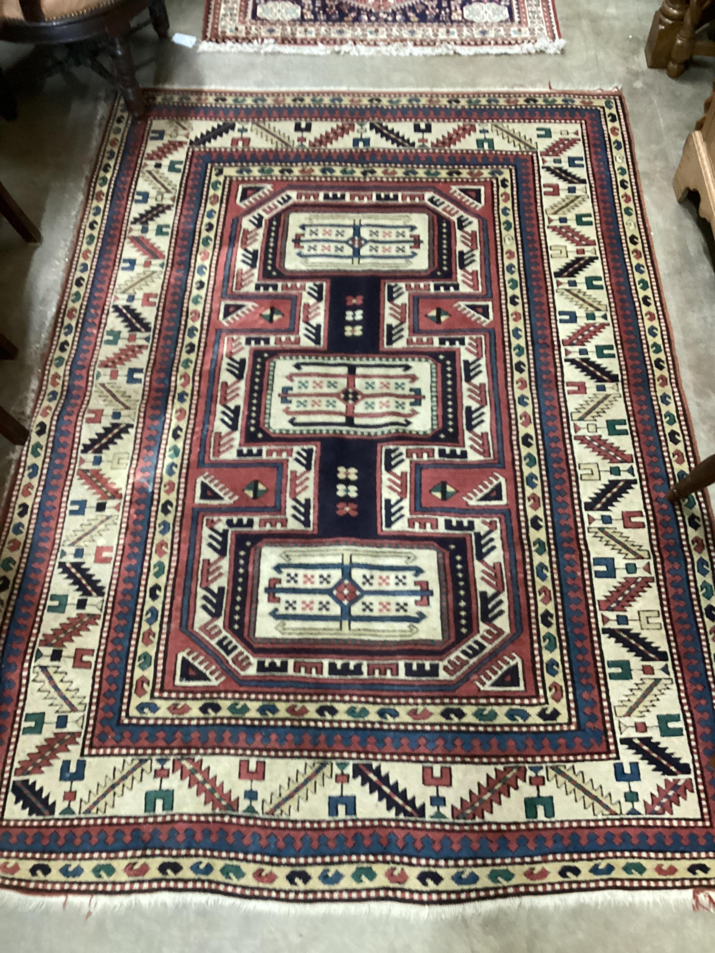 A Caucasian red ground rug, 205 x 142cm